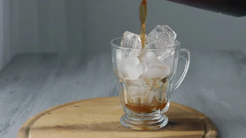 Pouring Cold Brewed Coffee over Ice. Stock Footage 170605355