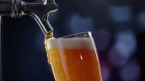 Pouring cold craft light beer with bubbles into glass  Stock Footage 257664449