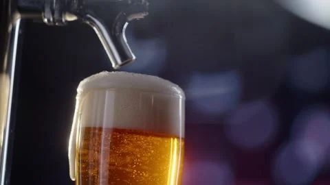 Pouring cold craft light beer with bubbles into glass  Stock Footage 257664553