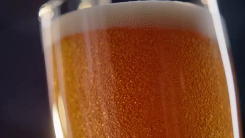 Pouring cold craft light beer with bubbles into glass  Stock Footage 257665229