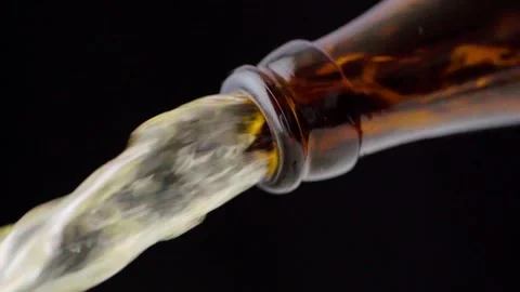 Pouring cold craft light beer from brown bottle Video stock 257665473