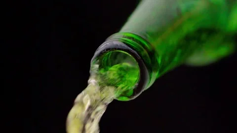 Pouring cold craft light beer from green bottle Stock Footage 257665505