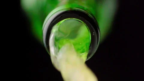 Pouring cold craft light beer from green bottle Stock Footage 257665508