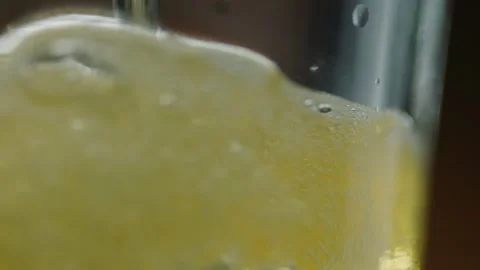 Pouring cold craft light beer with bubbles into glass  Stock Footage 257665566