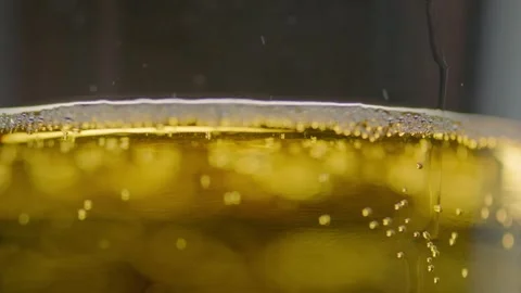 Pouring cold craft light beer with bubbles into glass  Stock Footage 257665577