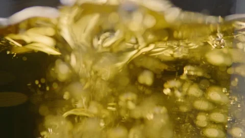 Pouring cold craft light beer with bubbles into glass  Stock Footage 257665603
