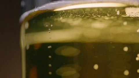 Pouring cold craft light beer with bubbles into glass  Stock Footage 257665614