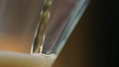 Pouring cold craft light beer with bubbles into glass  Stock Footage 257665620