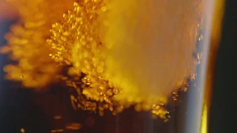 Pouring cold craft light beer with bubbles into glass  Stock Footage 257665629