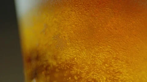 Pouring cold craft light beer with bubbles into glass  Stock Footage 257665641