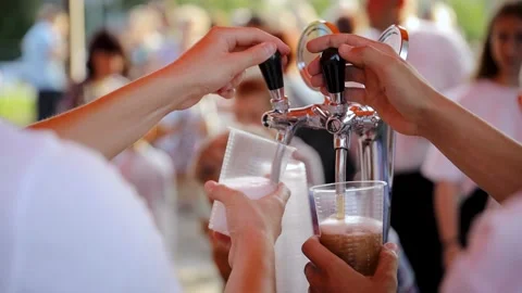 Pouring of cold drinks into a plastic glass. Bartender pouring craft beer in the Stock Footage 204124601