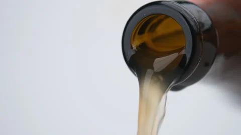 Pouring Cold Light Craft Beer into glass isolated on white background. Stock Footage 248435401