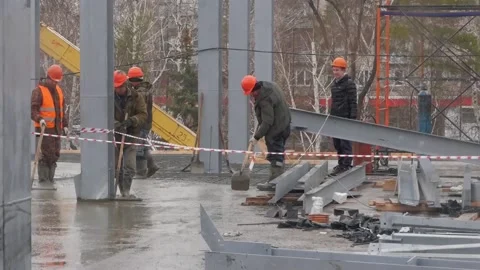 Pouring concrete on a construction site. Group of builders working together on Stock Footage 132201533