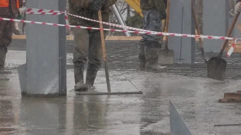 Pouring concrete on a construction site. Group of builders working together on Stock Footage 132201549