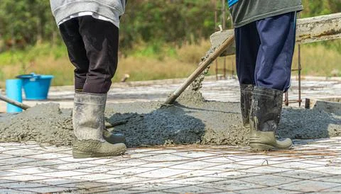 Pouring Concrete - Construction workers are pouring concrete between the comm Stock Photos