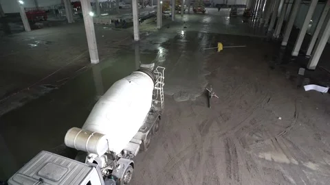 Pouring the concrete floor. Construction work inside of giant warehouse Stock Footage 218471127