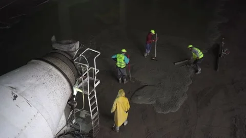 Pouring the concrete floor. Construction work inside of giant warehouse Stock Footage 218471196