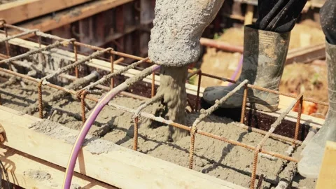 Pouring concrete into foundation formwork with rebar Stock Footage 341294831