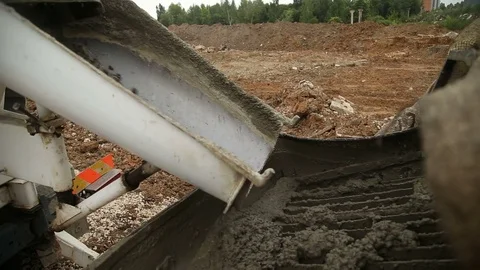 Pouring concrete mix from cement mixer on concreting formwork. Finished leveling Stock Footage