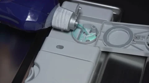 Pouring conditioner in container in dishwasher Stock Footage 146473801