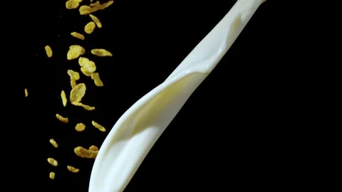 Pouring corn flakes in a stream of milk, Ultra Slow Motion Stock Footage 86577726