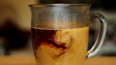 Pouring Cream into Coffee Stock Footage 115918448