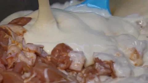 Pouring Cream Sauce Over Raw Marinated Chicken Meat close-up Video stock 343027465