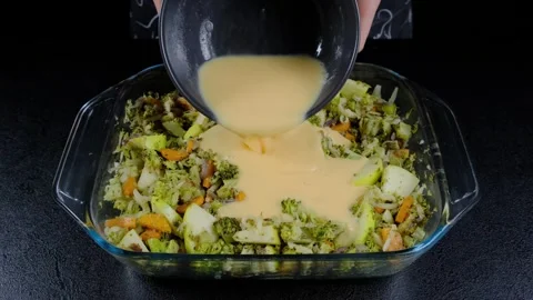 Pouring Cream Sauce Over Vegetables in Glass Dish Cooking Video stock 341440341