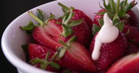 Pouring cream on strawberry Stock Footage 58299875