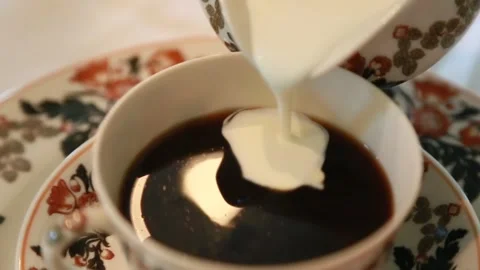 Pouring cream in tea Stock Footage 239297771