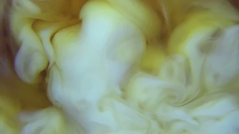 Pouring a cream in transparent cup with hot tea, slow motion Stock Footage 80962005