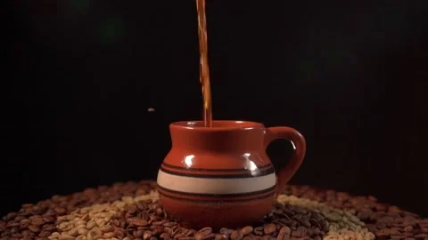 Pouring a Cup of coffe on a table with coffee beans in slow motion 库存影片 162093267