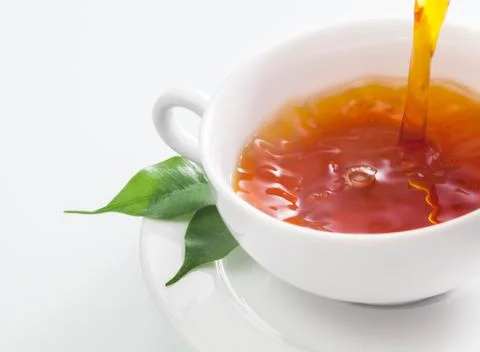 Pouring a cup of refreshing tea Stock Photos