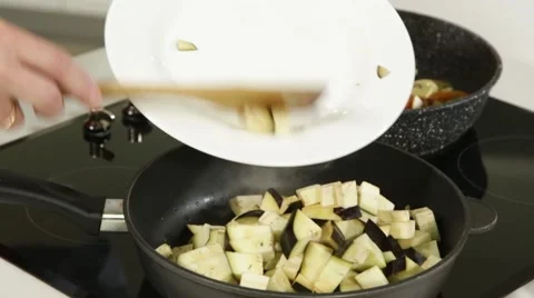 Pouring cut squash in a pan Stock Footage 49783230