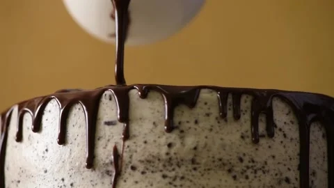 Pouring dark chocolate icing on the cake. Cooking the cake. Cooking a festive Stock Footage 148391681