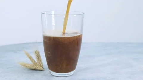 Pouring dark soft drink into a glass Stock Footage 133448448