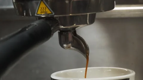 Pouring of delectable coffee from coffee machine closeup Video stock 266156114