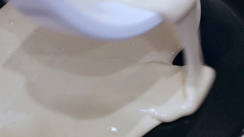 Pouring dough of cake in pan Stock Footage 99572592