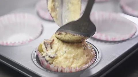 Pouring dough into forms for muffins.Process of preparing muffins. Stock Footage 151043439