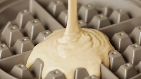 Pouring dough into waffle maker Stock Footage 128987498