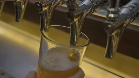 Pouring Draft Beverage from Tap into Glass at Bar Counter in Beijing, China Stock Footage 345756540