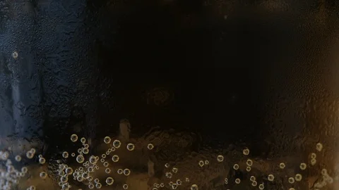 Pouring a draught lager beer from the top glass forming waves Stock Footage 87196637