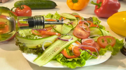 Pouring dressing onto salad, slow motion Stock Footage 61786440
