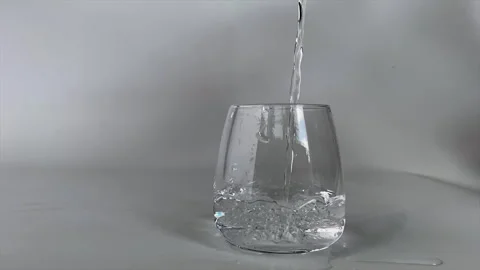 Pouring drinking water into a glass Stock Footage 252563103