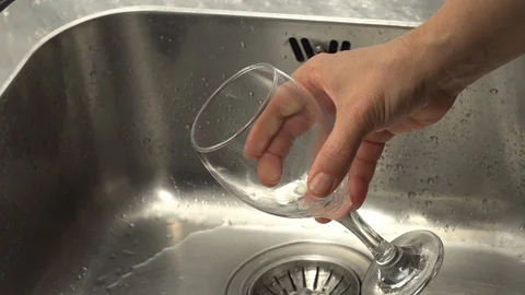 Pouring  drinking water from a kitchen tap into a glass. Stock Footage 108317804