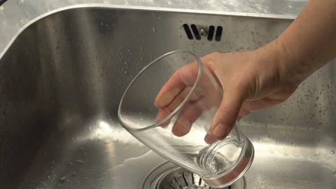Pouring  drinking water from a kitchen tap into a glass. Stock Footage 108318163