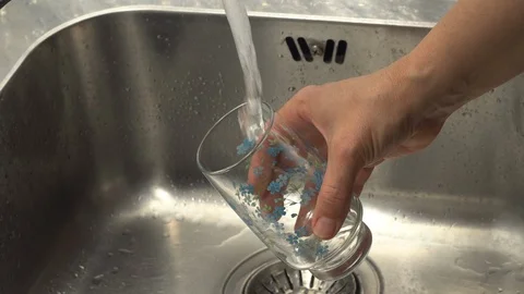 Pouring  drinking water from a kitchen tap into a glass. Video stock 108318348