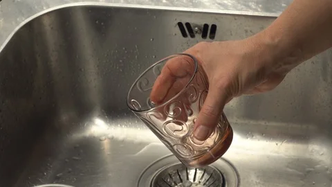Pouring  drinking water from a kitchen tap into a glass. Video stock 108318564