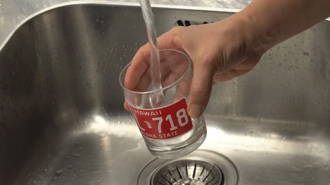Pouring  drinking water from a kitchen tap into a glass. Stock Footage 108318720