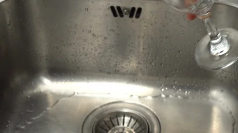 Pouring  drinking water from a kitchen tap into a glass. Video stock 108318837